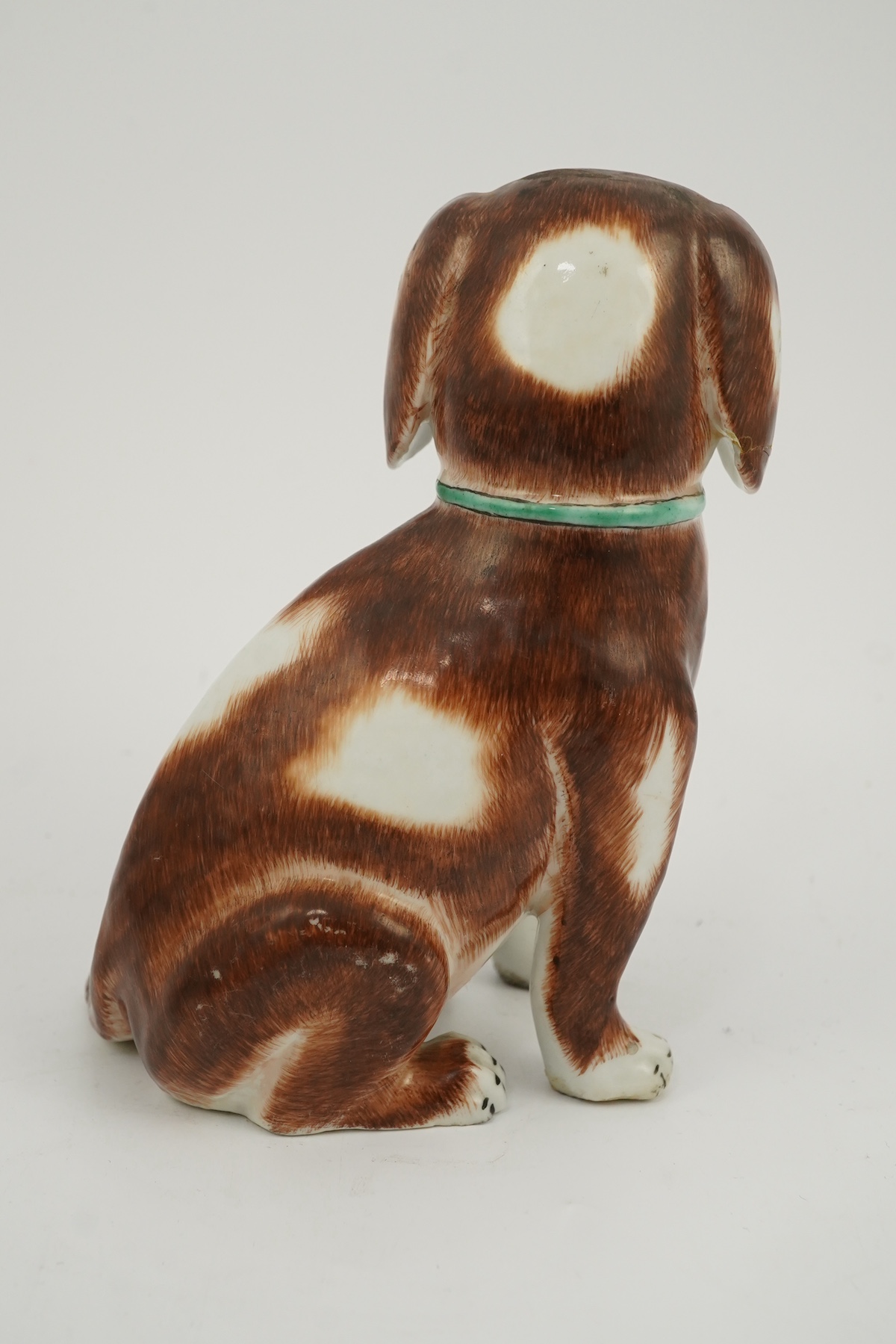 A Chinese export enamelled porcelain model of a seated spaniel, Qianlong period
